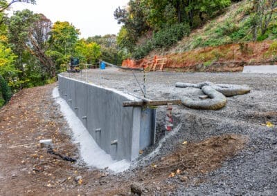 The beginning of a new shotcrete soldier pile wall built by Pacific Foundation to support the embankment on a steep slope.