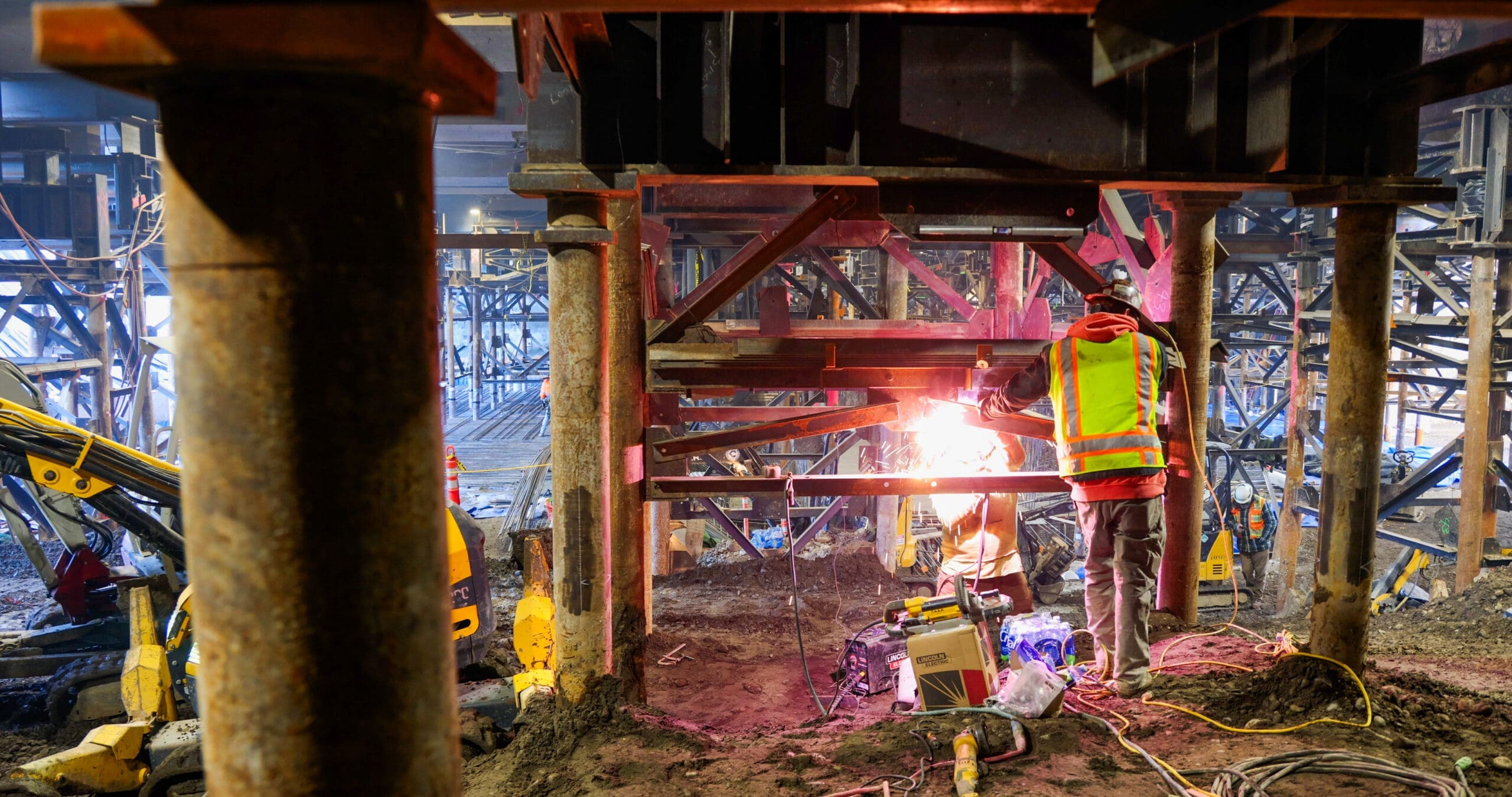 A welder fabricates a steel tower under the Oregon state capitol